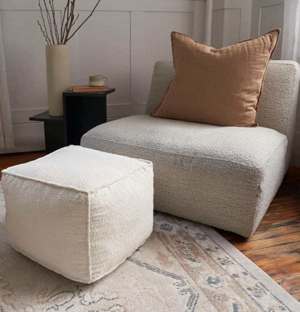Textured boucle round pouf foot stool filled with soft sponge, lightweight modern decorative foot rest to match living room interior